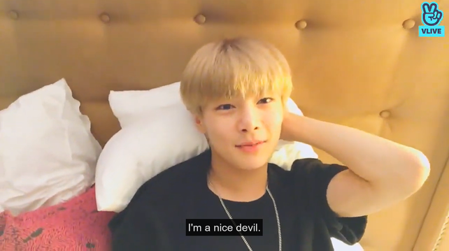 I.N in bed, looking at the camera and touching the back of his head with one hand. He says, 'I'm a nice devil.'