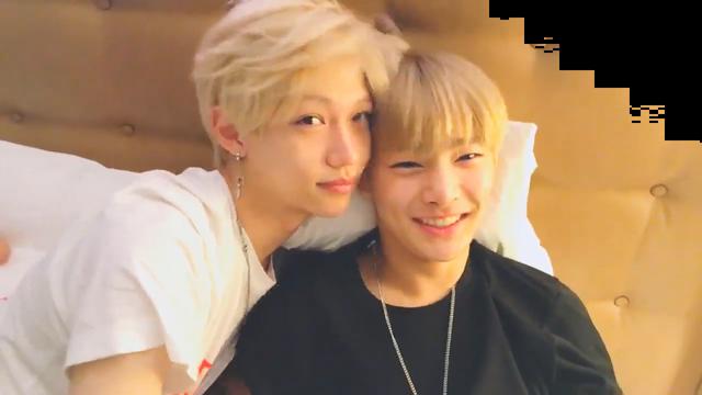 Felix and I.N with their heads close together, looking at the camera.
