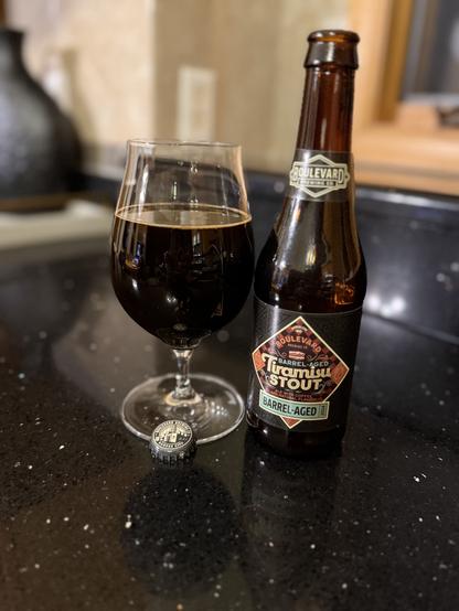 A few all snifter glass of dark beer Elbert to a 12 pounce bottle with a body label on brown and tan and a neck label with white lettering and the Boulevard logo