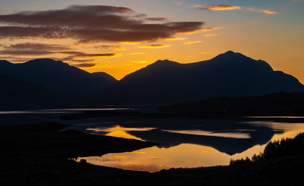 Golden sky and dark mountains.