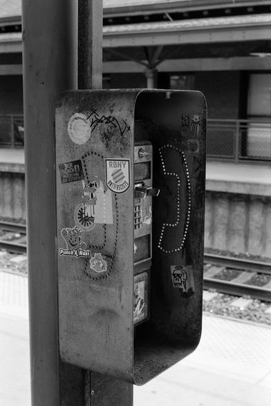 An old and disused telephone booth with political/anti-fascist stickers on it