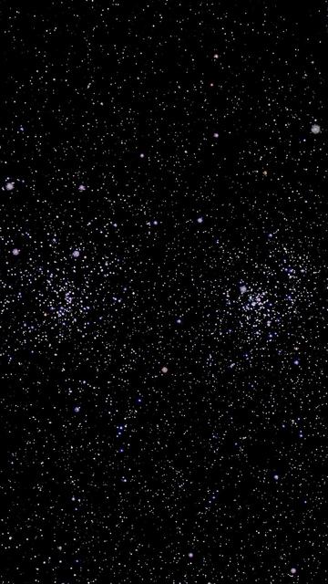 A cosmic scene filled with numerous stars and galaxies against a black background, showcasing a variety of colors including white, blue, and purple.