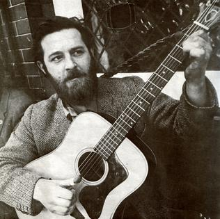 Ciarán Bourke holding a guitar.