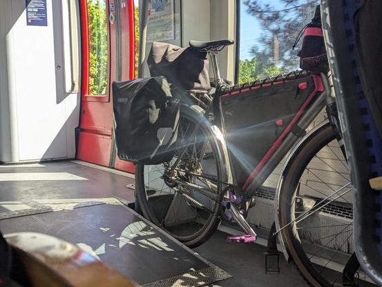 a bicycle leaned against a train car window