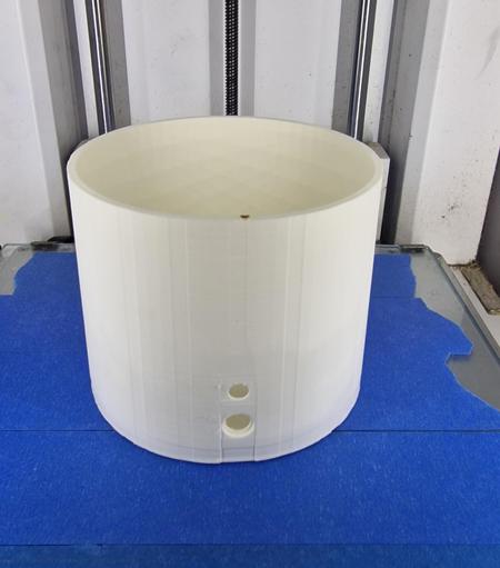 White 3d print of the St John's beacon sat on blue tape.