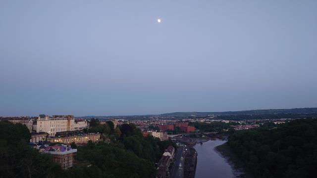A late evening photo of Bristol, taken from Clifton Suspension bridge. The river Avon is visible in the bottom right. The moon was big and bright to the eye, but looks tiny in the photo.