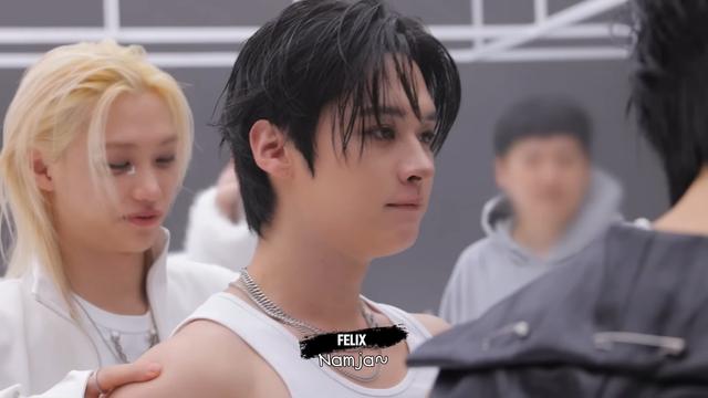 Felix stands behind Lee Know, squeezing his bare shoulders, looking down appreciatively at his back (and/or bum?) and says, 'Man.'