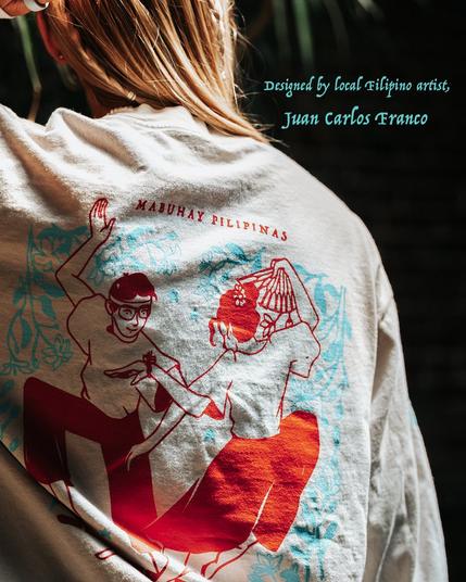 Close of up the back of Mace wearing our AANHPI long-sleeved shirt and text on the photo that says, "Designed by local Filipino artist, Juan Carlos Franco"