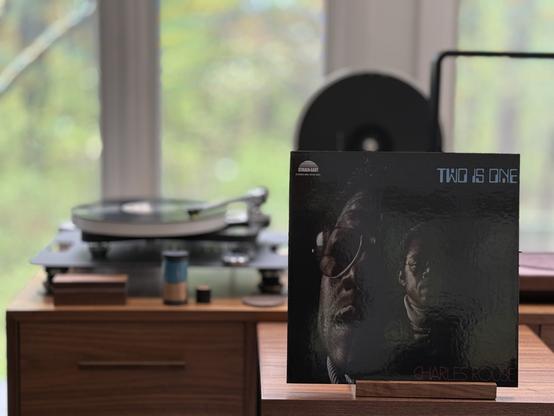 Charles Rouse - Two is One LP cover.

On a black background, two half-lit portraits of Charles Rouse, one large, one small.

The black LP plays on a Rega NAIA turntable to the left.