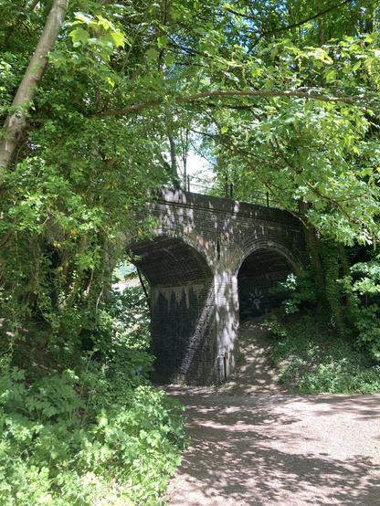 This disused railway bridge viewed from below now carries cyclists along a greenway.