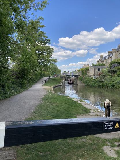 The Avon and Somerset Canal in Bath with a canal boat exiting a lock.