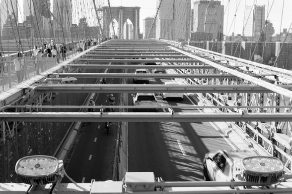 A view toward manhattan across the Brooklyn bridge, over the car traffic