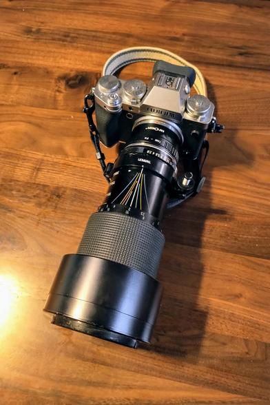 Fuji xt5 with a tamron Sp 30a lens on a wooden table