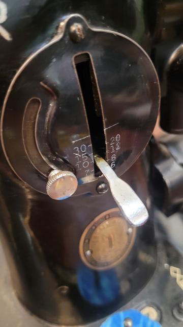 Settings visible on an old black sewing machine