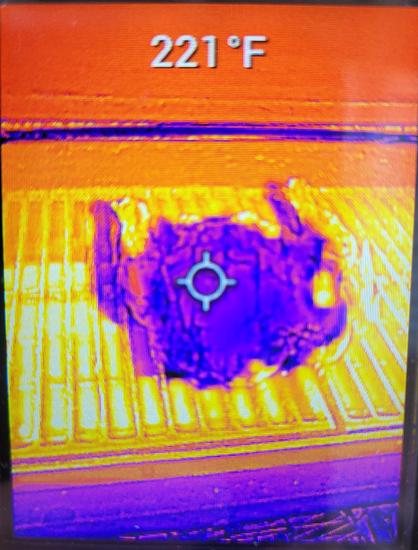 Image on a screen showing a purple, chicken shaped object over a bright orange grill shape