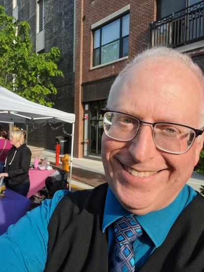 Selfie of ordinary old white guy with glasses, a tie, and vest. Looks vaguely psychic.