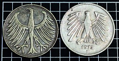 Obverse of 1951 and (non-cancelled) 1975 D coin showing differences in eagle designs.
