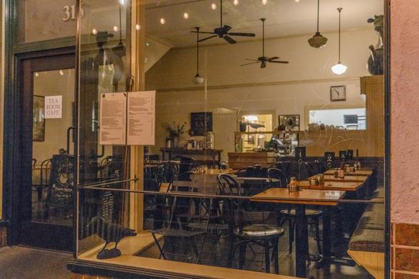 A photograph of a diner that's closed for the night. The clock on the back wall of the diner indicates 5:53am.