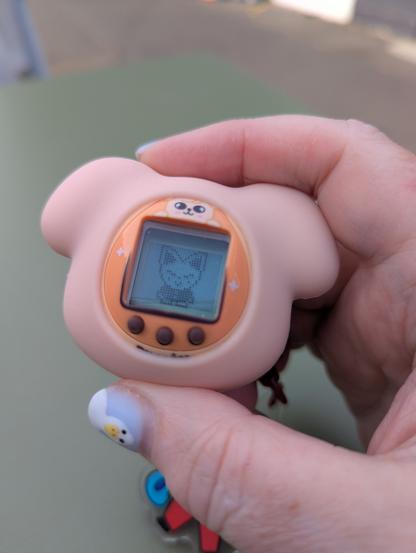 Game side of a PuppyM tamagotchi, showing a happy FoxINy