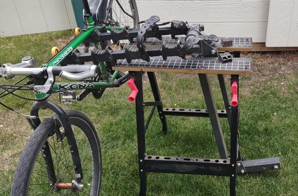 Bike tuning station built out of a folding workbench and a car hitch bike rack.