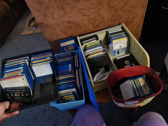 photo of about 200 floppy disks of various colours