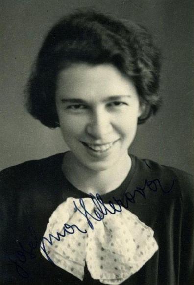 A portrait photo of the face of a young smiling woman.
