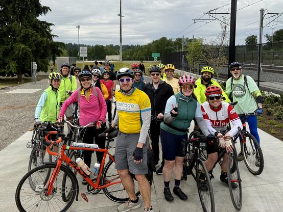 Group of cyclists including myself standing next to the Marymoor Village light rail station with the Gerry Baker Velodrome in the background