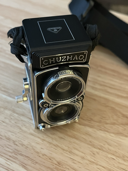 A closeup of the Chuzhao “TLR” toy camera.