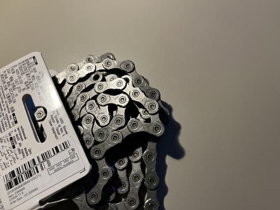 Chain unboxed with "KMC" and "X11" engraved into the chain.
