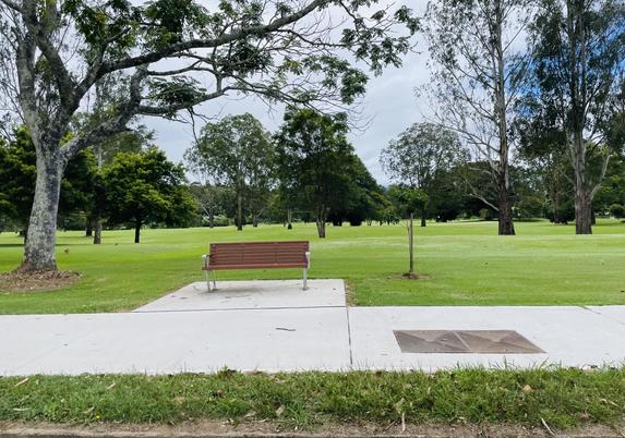 Bellingen Golf Club with new impervious surface pavement. Surrounded by puddles and small lakes now. The new bench is facing the busy Waterfall Way.