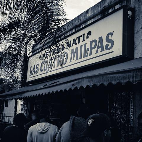 Line of folks waiting outside of Las Quatro Milpas, a San Diego restaurant.