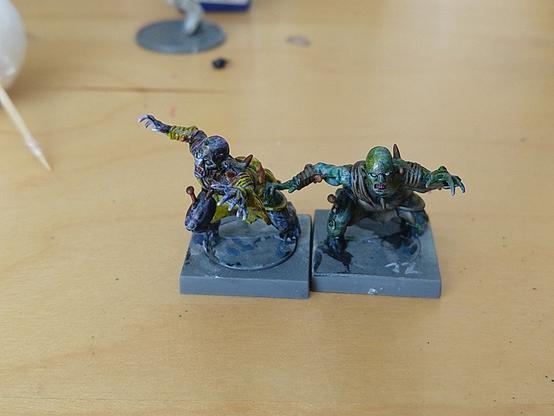 Two mantic ghoul miniatures, painted in different schemes of blues, greens and dirt.