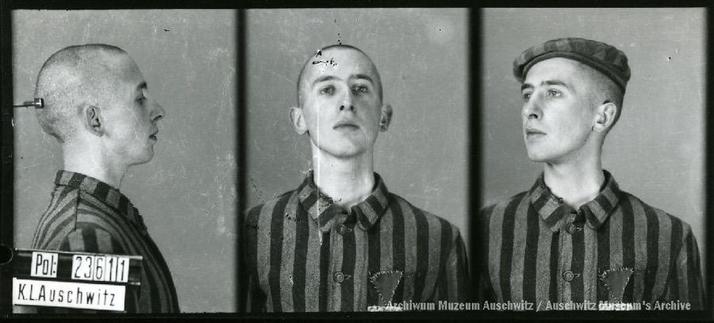 A mugshot registration photograph from Auschwitz. A man with a shaved head wearing a striped uniform photographed in three positions (profile and front with bare head and a photo with a slightly turned head with a hat on). The prisoner number is visible on a marking board on the left.