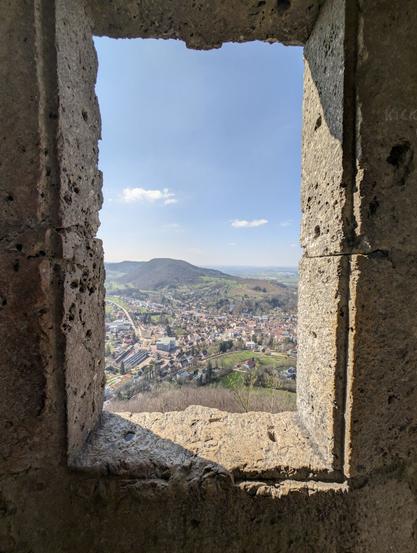 Charming view through a window opening of the Rosenstein ruin towards Heubach.
