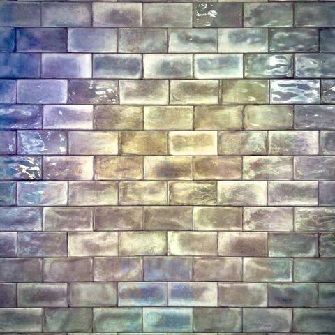 Glossy wall tiles reflect pastel hues of warm, cool, and neutral colors.