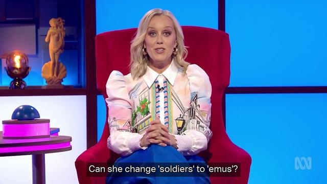 Claire is a woman aged about 40, fair skin and blonde hair. She wears a blouse patterned with a street scene. Caption: "can she change 'soldiers' to 'emus'?"