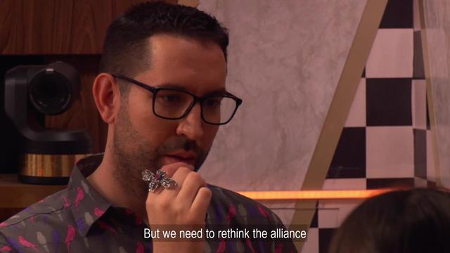 Ben, a bespectacled man in his late twenties looks uncertain; his hand is raised to his mouth, showing he's wearing a ring in the shape of a butterfly. Caption: "But we need to rethink the alliance."