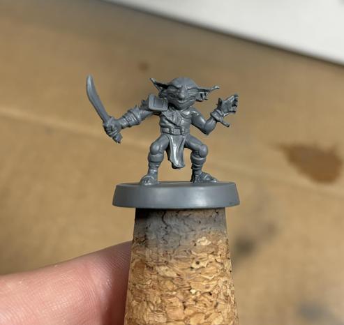 Goblin miniature from Hero Quest, base painted grey. Front.