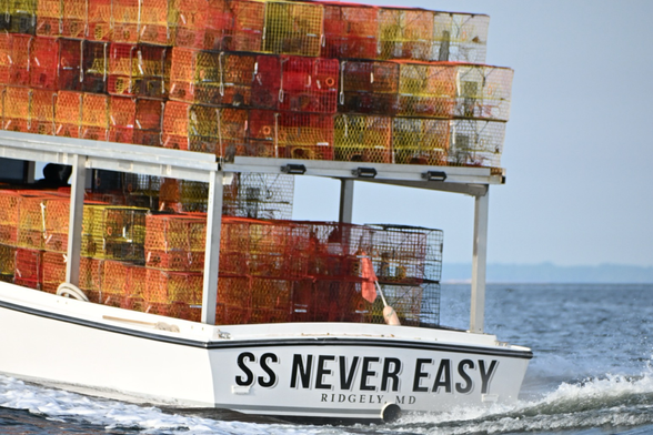 Crab boat piled high with crab pots.