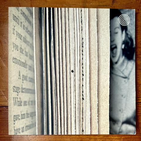 The cover of Issue 1 of Inscription Journal. It is square and has a hole in the center.
