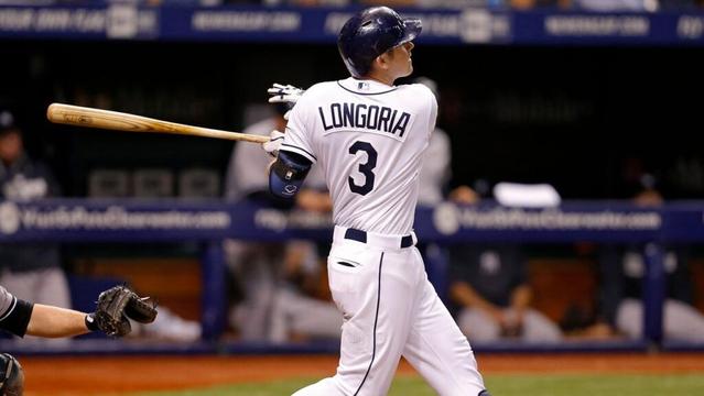 FILE — Tampa Bay Rays' Evan Longoria follows through on a two-run home run in front of New York Yankees catcher Brian McCann during the third inning of a baseball game Saturday, April 19, 2014, in St. Petersburg, Fla. (AP Photo/Mike Carlson)