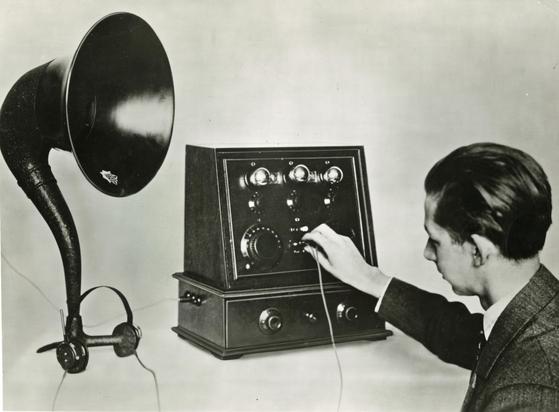 Mann beim Hören von Musik aus einem Telefunken Radioapparat (um 1925) | CC BY SA 4.0 Museumsstiftung Post und Telekommunikation / Foto: unbekannt.