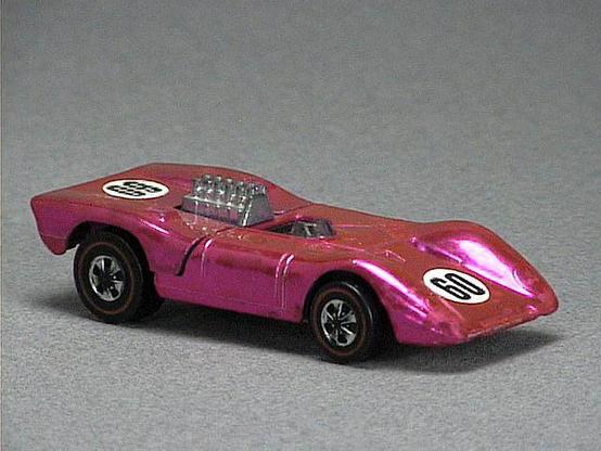 Released in 1970, Spectraflame Green Ferrari 312P of 1970 Grand Prix with Redline wheels. Notes: Back lifts up and has an exposed metal engine. HK casting has protruding door outline and a shiny black rear panel. Packaging: Grand Prix. Metal Body, Metal Base. Made in Hong Kong. Scarcity: 3/10