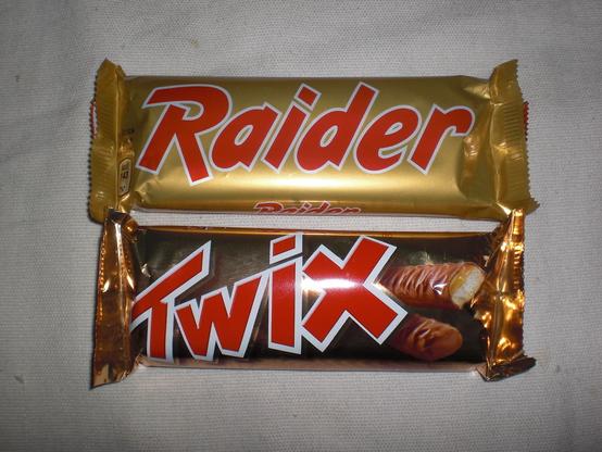 Side-by-side picture of a wrapped Twix chocolate bar, next to its pre-1991 "Raider" equivalent.