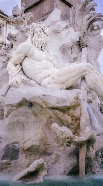 A statue of the river god Ganges, shown bearded and reclining in a fountain