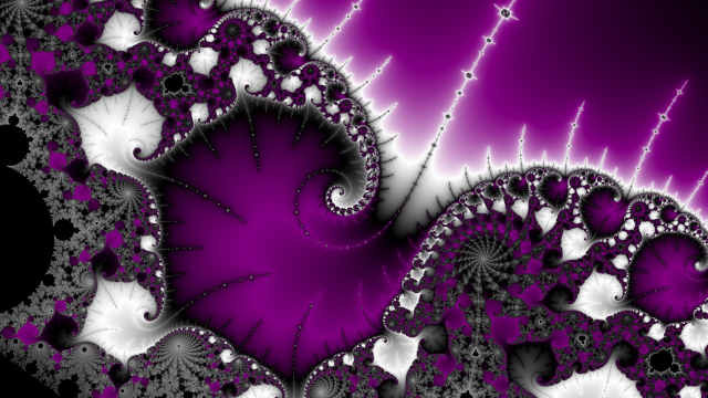 Spiraling Mandelbrot image, ace color scheme. It’s tilted towards the right. Some antennas reaching out to the top right corner.