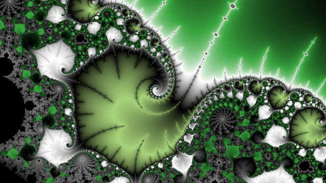 Spiraling Mandelbrot image, aro color scheme. It’s tilted towards the right. Some antennas reaching out to the top right corner.