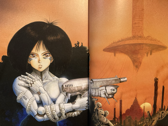 A two page spread with Alita and the city of Zalem