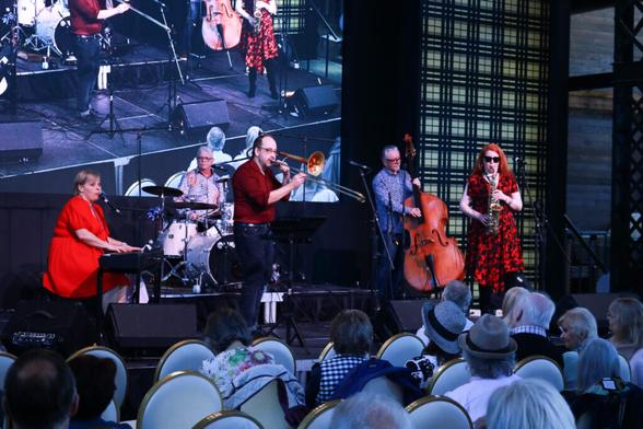 Photo of an ensemble of jazz musicians performing on stage for for an audience as part of the Galt Jazz Festival in Cambridge, Ontario.