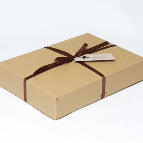 Picture shows a closed A4 box tied with brown ribbon.